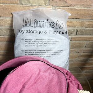 NEW Toy Storage and Play Mat. Mat is attached to bag.Pull drawstring & go.